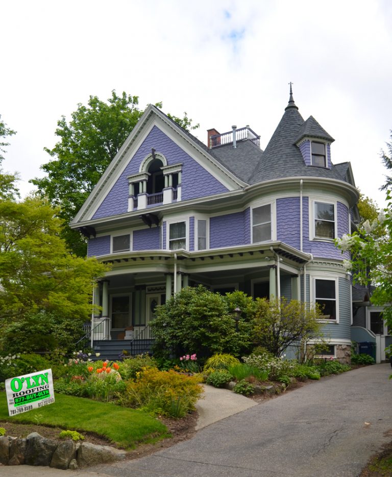 Purple victorian home with a new roof courtesy of O'LYN Roofing