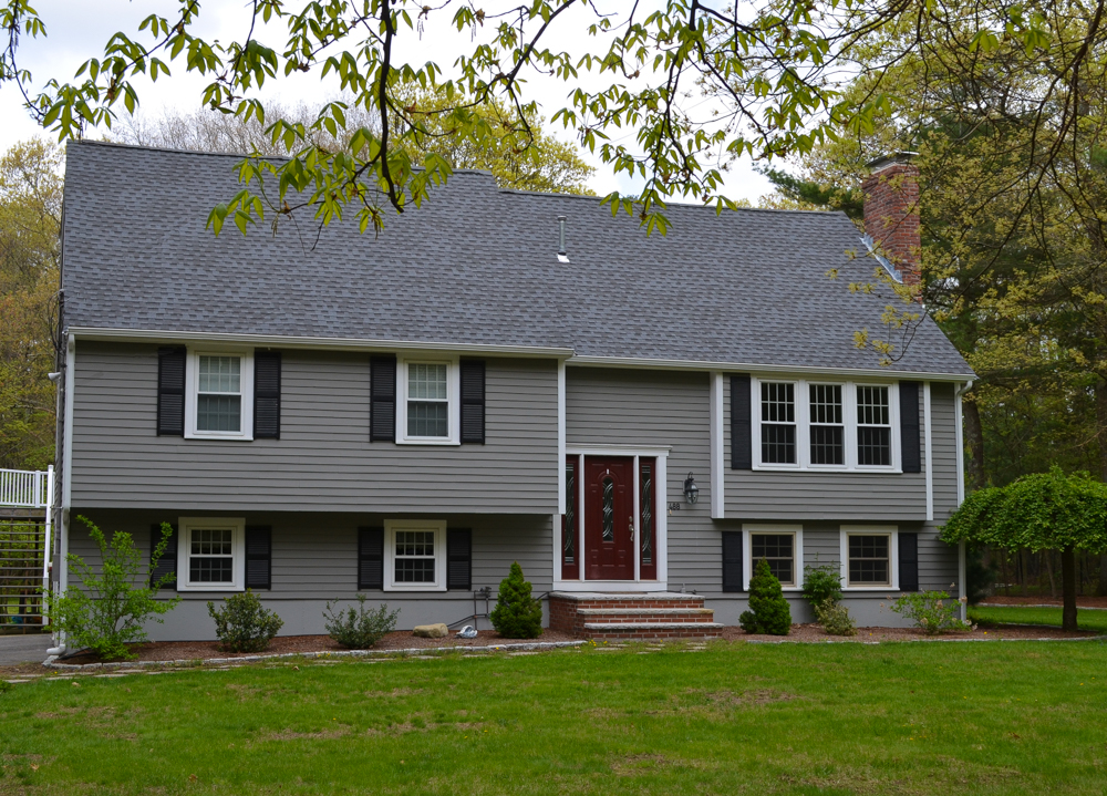 A two story home in MA with a new roof installed by O'lyn Roofing