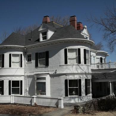 An antique home with wood gutters installed by O'lyn Roofing.