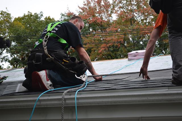 An O'lyn Roofing crew hard at work installing new shingles on a home.