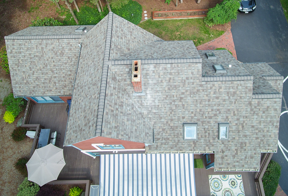 Overhead view of a home with a new roof installed by O'lyn Roofing