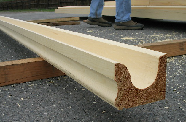A closeup picture of an unfinished wood gutter.