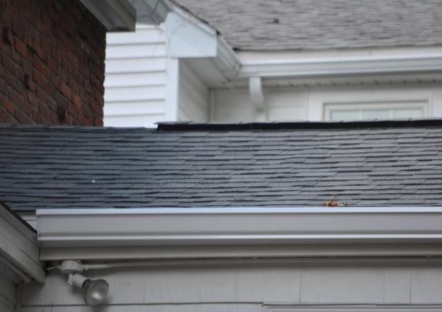 After picture of a roof in newton with new shingles and a ridge cap.