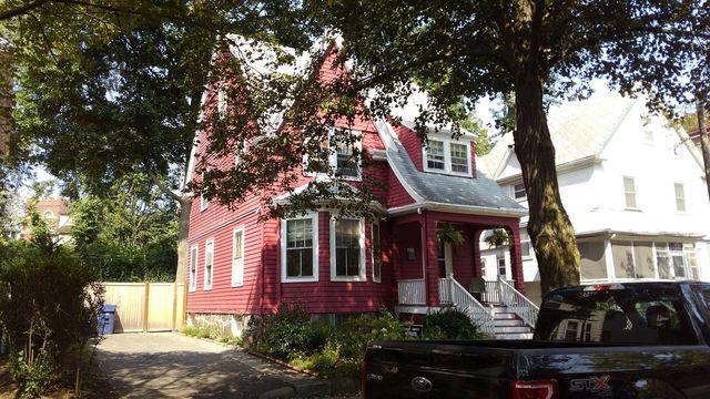 Image of a red home before work was done by O'lyn Roofing
