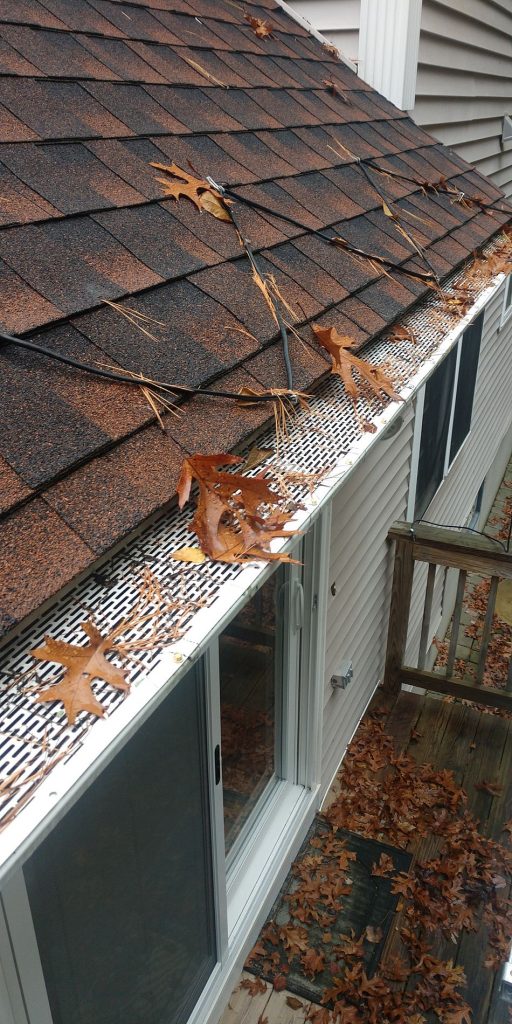 A gutter with gutter guards installed.
