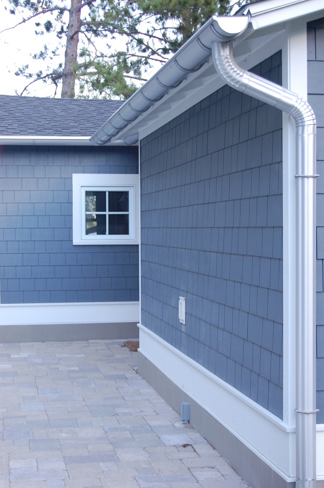  A building with new gutters and downspouts. 