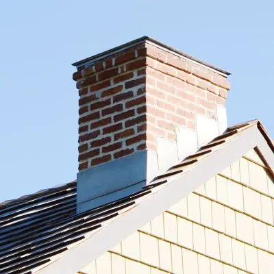 a chimney with roof flashing at the seam