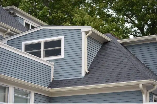 image of a portion of a hours with multiple roof edges. Along each edge is a gutter.