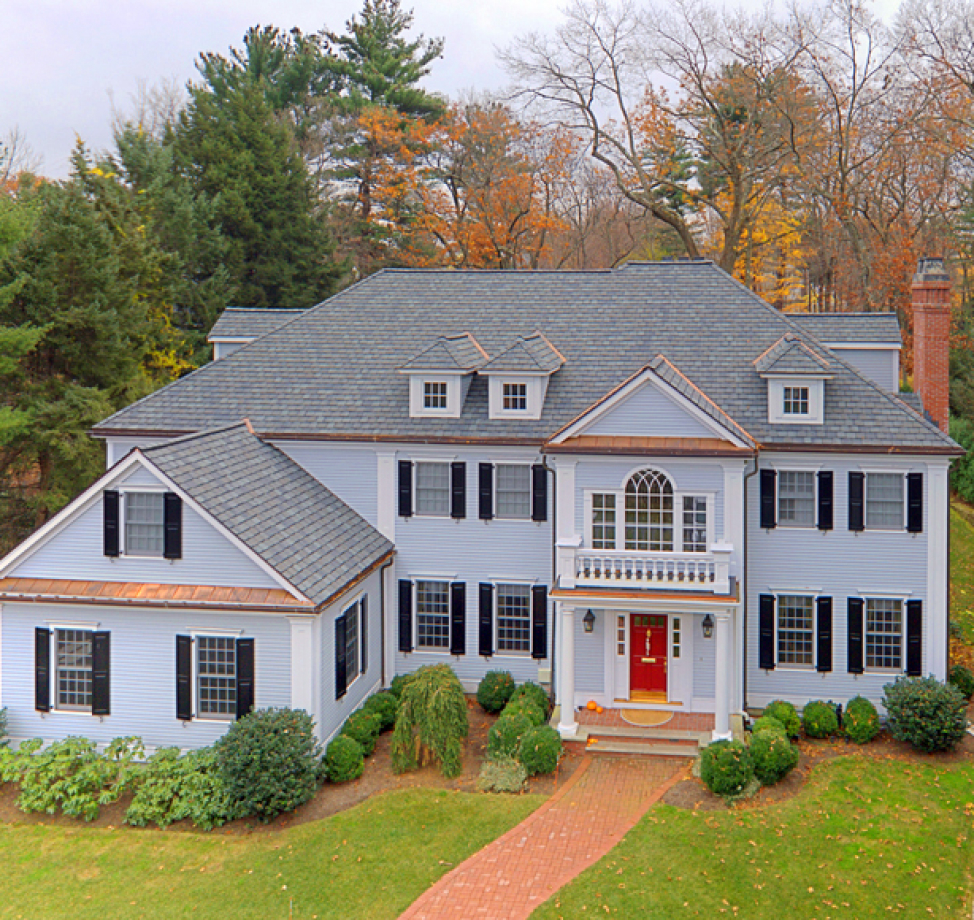 Large colonial home with new gray asphalt shingle roof and copper accents