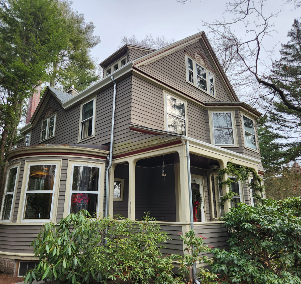 Victorian style home with new gray asphalt shingle roof and brown siding
