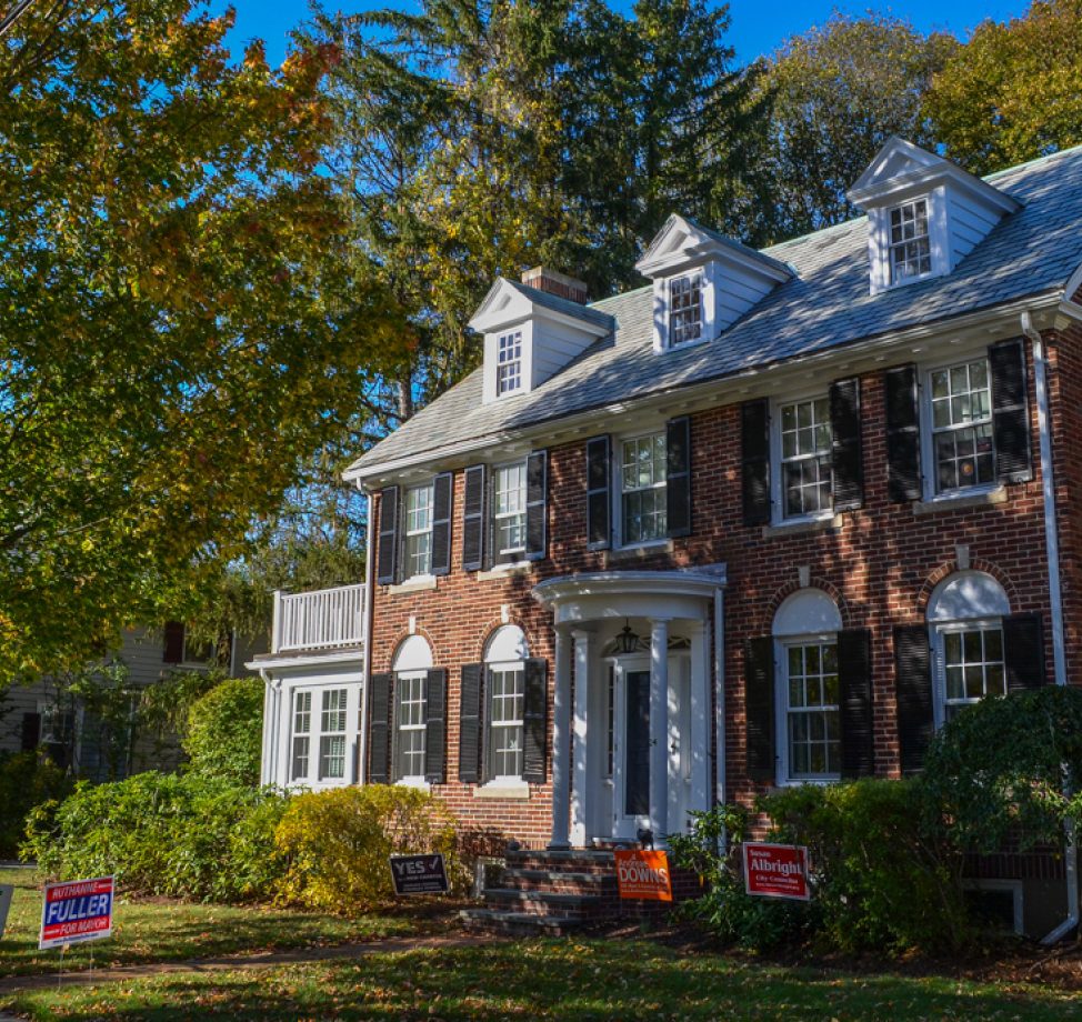 Brick colonial home with new gray asphalt shingle roof and dormer windows