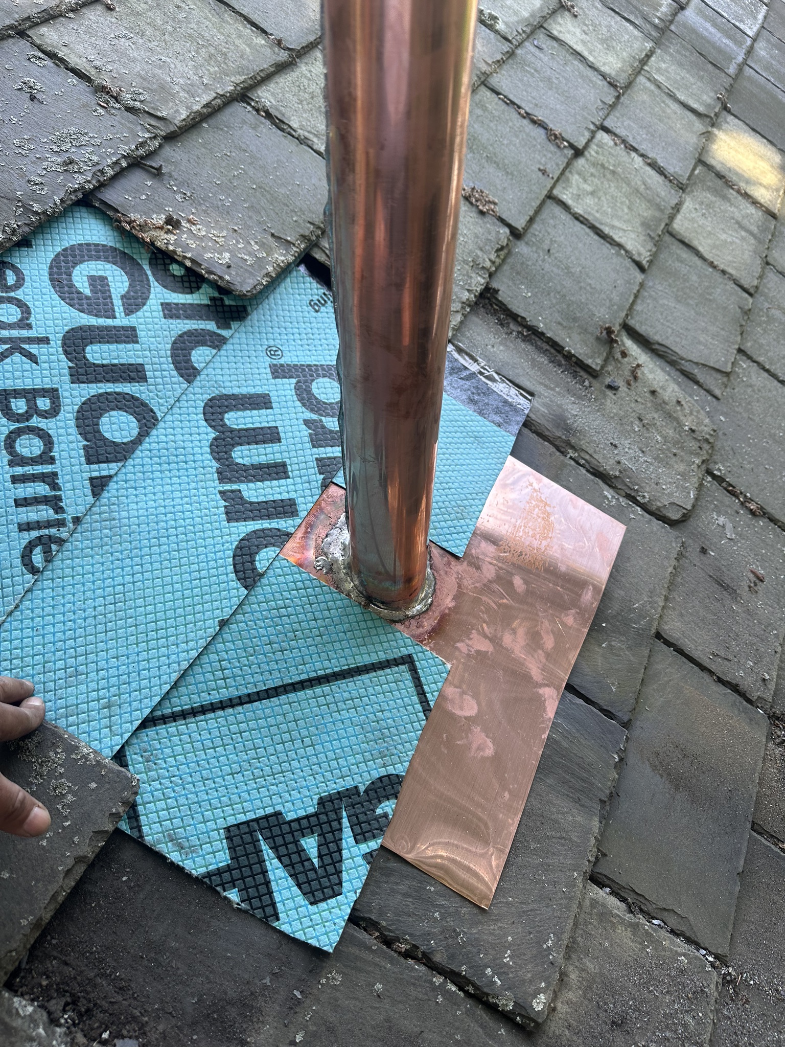 copper vent pipe on slate roof